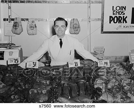 Stock Image - 1930S 1940S Portrait Smiling Man Butcher Grocer At Meat Counter. Fotosearch