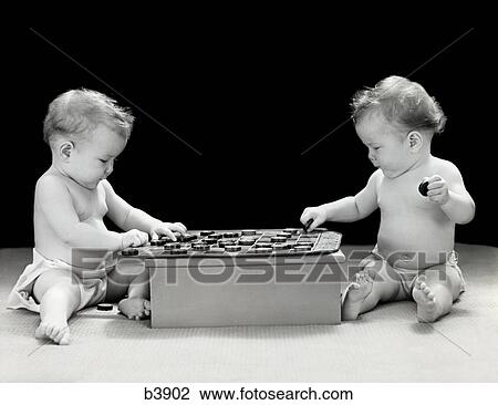 1930S 1940S Twin Babies Playing Game Of Checkers Together Studio View Large Photo Image Stock Image - 1930S 1940S Twin Babies Playing Game Of Checkers Together Studio. Fotosearch