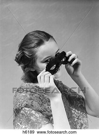 1930S 1940S Woman Putting On Taking Off Black Eye Mask View Large Photo Image Stock Photo - 1930S 1940S Woman Putting On Taking Off Black Eye Mask. Fotosearch