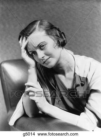 1930S 1940S Woman Sitting In Chair Worried Sad Expression One Hand Up To Her Forehead View Large Photo Image Picture - 1930S 1940S Woman Sitting In Chair Worried Sad Expression One Hand Up To Her Forehead . Fotosearch