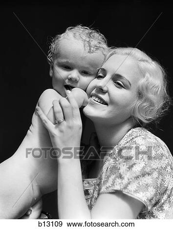 1930S Blonde Woman Mother Smiling Holding Baby To Cheek View Large Photo Image Stock Photo - 1930S Blonde Woman Mother Smiling Holding Baby To Cheek. Fotosearch