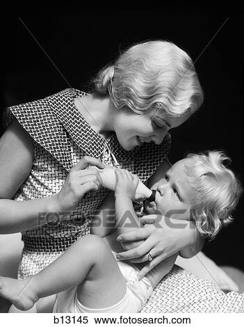 1930S Blonde Woman Mother Smiling Feeding Baby Bottle View Large Photo Image Stock Photography - 1930S Blonde Woman Mother Smiling Feeding Baby Bottle. Fotosearch