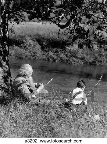 1930S Boy & Grandfather Fishing On Bank Of Stream View Large Photo Image Stock Image - 1930S Boy & Grandfather Fishing On Bank Of Stream. Fotosearch