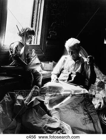 1930S Boy Holding Toy Sailboat Watching Grandfather Sew Sail View Large Photo Image Stock Photograph - 1930S Boy Holding Toy Sailboat Watching Grandfather Sew Sail. Fotosearch