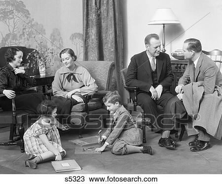 1930S Family Mother Father Two Kids Playing On Floor Visiting With Another Couple View Large Photo Image Stock Image - 1930S Family Mother Father Two Kids Playing On Floor Visiting With Another Couple. Fotosearch