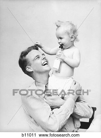 1930S Father Holding Baby In Arms Smiling Milk Bottle View Large Photo Image Stock Image - 1930S Father Holding Baby In Arms Smiling Milk Bottle. Fotosearch