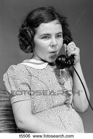 Stock Photograph - 1930S Girl Talking On Telephone Surprise Expression. Fotosearch