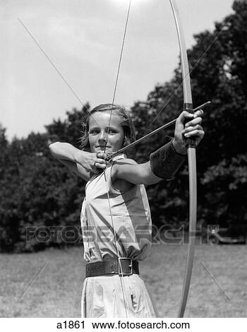 1930S Girl Wearing A Camp Jumper With Wide Leather Belt About To Release An Arrow From Bow View Large Photo Image Stock Image - 1930S Girl Wearing A Camp Jumper With Wide Leather Belt About To Release An Arrow From Bow. Fotosearch