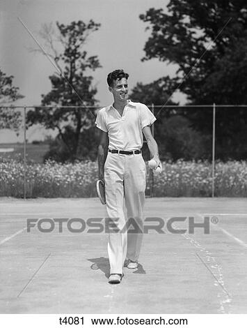 1930S Man Walking Across Tennis Court Holding Tennis Racket & Balls View Large Photo Image Stock Image - 1930S Man Walking Across Tennis Court Holding Tennis Racket & Balls. Fotosearch