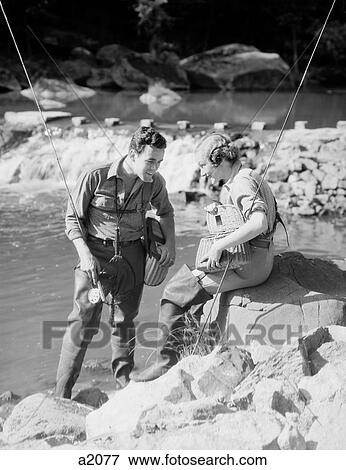 Stock Photo - 1930S Man Woman In Waders Fly Fishing By Stream. Fotosearch