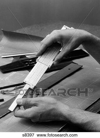 Stock Photo - 1930S Man'S Hands Using Slide Rule Over Drafting Table. Fotosearch