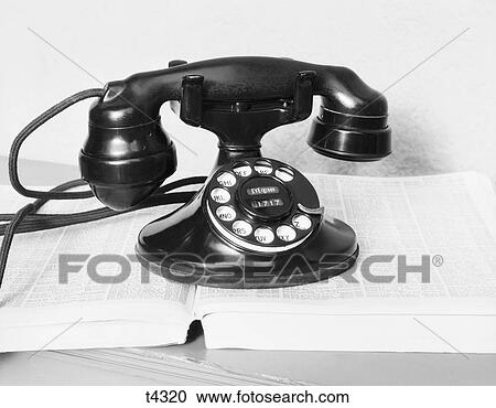 1930S Old Black Rotary Dial Cradle Telephone On Open Telephone Number Directory Book View Large Photo Image Stock Image - 1930S Old Black Rotary Dial Cradle Telephone On Open Telephone Number Directory Book . Fotosearch