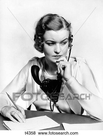 1930S Portrait Business Office Woman Receptionist Wearing Headphones And Speaker Microphone Looking Worried And Concerned View Large Photo Image Stock Photo - 1930S Portrait Business Office Woman Receptionist Wearing Headphones And Speaker Microphone Looking Worried And Concerned. Fotosearch