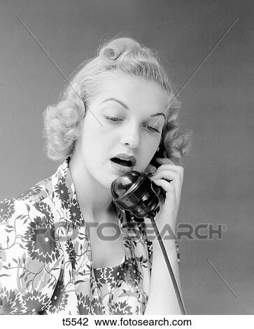 1930S Portrait Of Blond Woman In Print Dress Talking On Telephone Surprised View Large Photo Image Stock Image - 1930S Portrait Of Blond Woman In Print Dress Talking On Telephone Surprised . Fotosearch