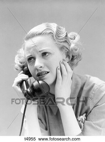 Stock Photography - 1930S Portrait Worried Upset Woman Talking On Telephone . Fotosearch