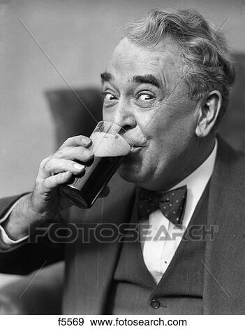 1930S Smiling Eyes Of Senior Man Drinking Beer From Glass View Large Photo Image Stock Photo - 1930S Smiling Eyes Of Senior Man Drinking Beer From Glass. Fotosearch
