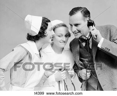 1930S Smiling Man In Suit New Father With Two Women Nurses Talking Good News On Telephone Hospital Medical Situation Lifestyle View Large Photo Image Stock Photo - 1930S Smiling Man In Suit New Father With Two Women Nurses Talking Good News On Telephone Hospital Medical Situation Lifestyle. Fotosearch