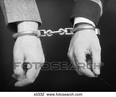 Stock Image - 1930S Two Men Handcuffed Together. Fotosearch