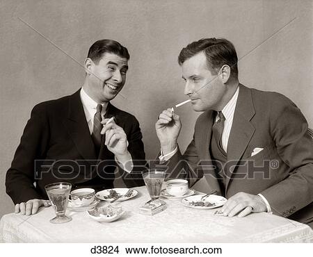 1930S Two Men Lighting After Dinner Cigarettes Smiling View Large Photo Image Picture - 1930S Two Men Lighting After Dinner Cigarettes Smiling. Fotosearch