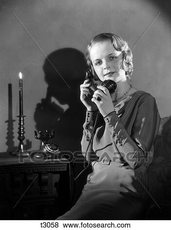 1930S Woman Talking On Telephone Casting Shadow On Wall View Large Photo Image Stock Photo - 1930S Woman Talking On Telephone Casting Shadow On Wall. Fotosearch