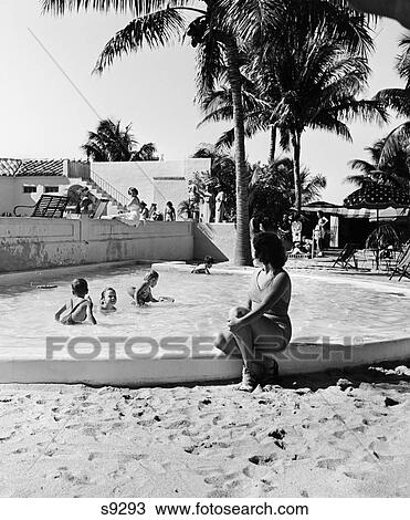 1930S Woman Watching Children Playing In Kiddy Pool View Large Photo Image Stock Image - 1930S Woman Watching Children Playing In Kiddy Pool. Fotosearch