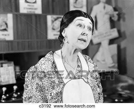 1930S Woman Wearing Apron Making Funny Expression Questioning View Large Photo Image Stock Image - 1930S Woman Wearing Apron Making Funny Expression Questioning . Fotosearch
