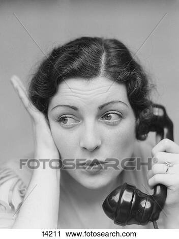 1930S Young Brunette Woman With Surprised Expression Hand To Head Talking On Telephone View Large Photo Image Stock Image - 1930S Young Brunette Woman With Surprised Expression Hand To Head Talking On Telephone. Fotosearch