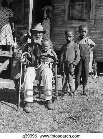 Stock Photography - 1939 Elderly African American Man Uncle Ambrose Douglas Aged 99 Once A Slave Is Holding The Youngest Of His 38 Children. Fotosearch