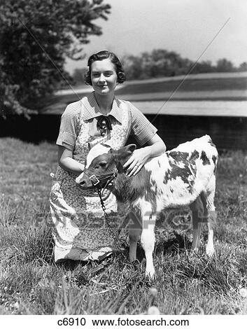 1940S 1950S Farm Woman In Apron Kneeling In The Grass With Young Jersey Calf View Large Photo Image Stock Image - 1940S 1950S Farm Woman In Apron Kneeling In The Grass With Young Jersey Calf . Fotosearch