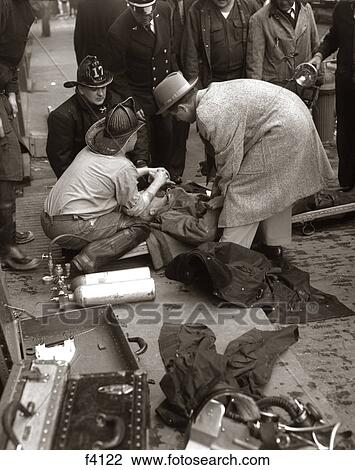 1940S 1950S Rescue Firemen And Bystander Help Use Resuscitator On Victim Overcome By Smoke View Large Photo Image Stock Image - 1940S 1950S Rescue Firemen And Bystander Help Use Resuscitator On Victim Overcome By Smoke. Fotosearch