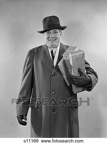 1940S 1950S Smiling Man Carrying Shopping Boxes Wearing Hat Coat Gloves Looking At Camera View Large Photo Image Stock Photo - 1940S 1950S Smiling Man Carrying Shopping Boxes Wearing Hat Coat Gloves Looking At Camera. Fotosearch