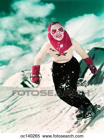 1940S 1950S Smiling Woman Skiing Downhill Wearing Goggles Red Hood And Red Gloves View Large Photo Image Stock Photography - 1940S 1950S Smiling Woman Skiing Downhill Wearing Goggles Red Hood And Red Gloves. Fotosearch