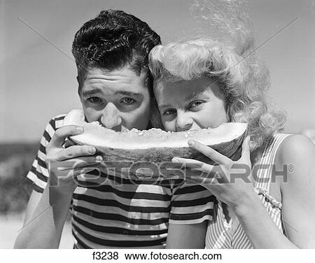 1940S 1950S Teen Age Boy & Girl Eating Slice Watermelon View Large Photo Image Stock Photo - 1940S 1950S Teen Age Boy & Girl Eating Slice Watermelon. Fotosearch