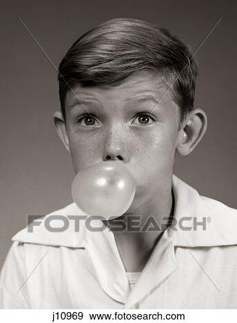 Stock Photo - 1940S 1950S Young Boy Blowing Bubble Gum Bubble. Fotosearch