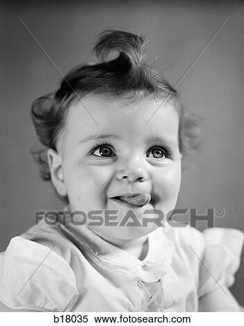 1940S Baby Girl Smiling Sticking Out Her Tongue View Large Photo Image Stock Photography - 1940S Baby Girl Smiling Sticking Out Her Tongue. Fotosearch