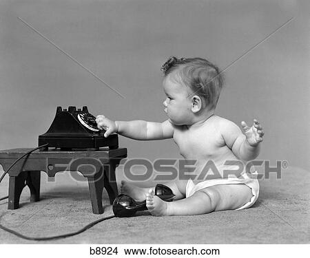 1940S Baby In Diaper Dialing Telephone View Large Photo Image Picture - 1940S Baby In Diaper Dialing Telephone. Fotosearch
