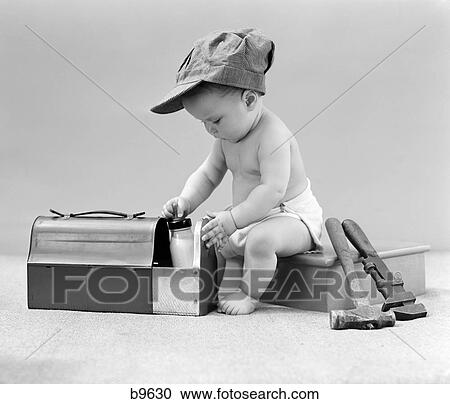 1940S Baby In Railroad Engineer Hat Pulling Milk Bottle From Lunch Pail With Hammer & Wrench Tools At Side Studio View Large Photo Image Stock Image - 1940S Baby In Railroad Engineer Hat Pulling Milk Bottle From Lunch Pail With Hammer & Wrench Tools At Side Studio. Fotosearch