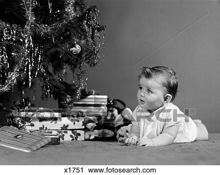 1940S Baby Laying In Front Of Christmas Tree And Christmas Presents View Large Photo Image Stock Image - 1940S Baby Laying In Front Of Christmas Tree And Christmas Presents. Fotosearch