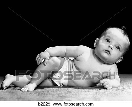 1940S Baby Laying On Side Propped Up On Elbow Legs Crossed Distracted Expression View Large Photo Image Stock Photography - 1940S Baby Laying On Side Propped Up On Elbow Legs Crossed Distracted Expression. Fotosearch