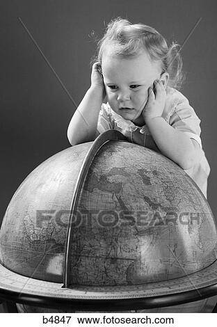 Stock Photo - 1940S Baby Looking At Leaning On Globe Of Earth. Fotosearch