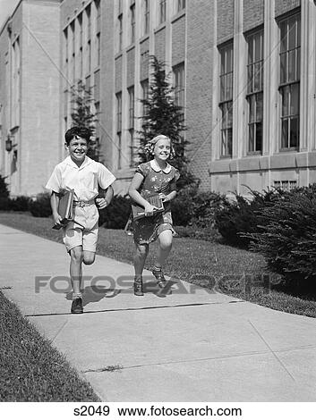 1940S Boy Girl Running Down Sidewalk Carrying School Books Smiling View Large Photo Image Stock Photo - 1940S Boy Girl Running Down Sidewalk Carrying School Books Smiling. Fotosearch