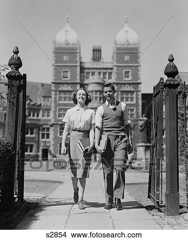 1940S College Aged Student Couple Walking Through Campus Gates University Of Pennsylvania View Large Photo Image Picture - 1940S College Aged Student Couple Walking Through Campus Gates University Of Pennsylvania. Fotosearch