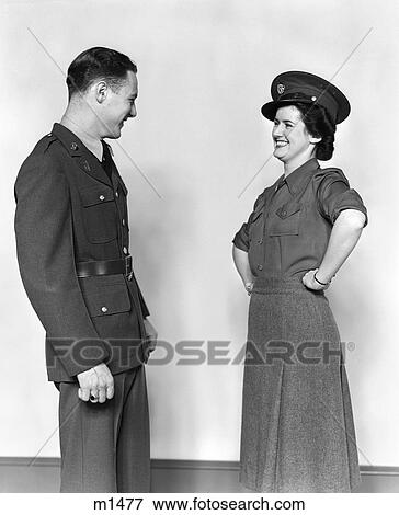 Stock Photo - 1940S Couple Man In Uniform Woman Smiling Wearing His Hat Hands On Hips. Fotosearch