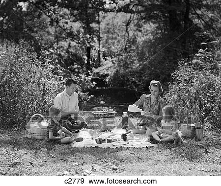 1940S Family Mother Father Son Daughter Picnicking With Barbecue Grill In Park View Large Photo Image Stock Photo - 1940S Family Mother Father Son Daughter Picnicking With Barbecue Grill In Park. Fotosearch