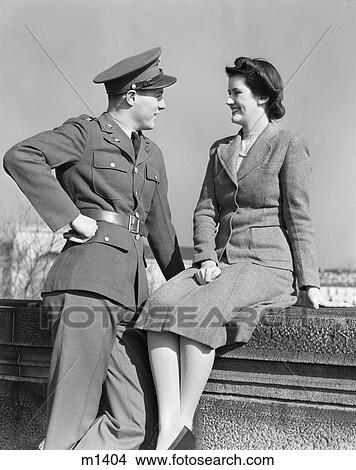 1940S Happy Couple Man Wearing Army Uniform Woman Sitting On Stone Wall View Large Photo Image Picture - 1940S Happy Couple Man Wearing Army Uniform Woman Sitting On Stone Wall. Fotosearch