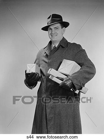 1940S Man Wearing Winter Coat Hat Gloves Holding Packages Parcels View Large Photo Image Picture - 1940S Man Wearing Winter Coat Hat Gloves Holding Packages Parcels. Fotosearch