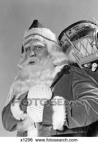1940S Portrait Of Smiling Santa Claus With A Sack For Of Toy Presents Slung Over His Shoulder Looking At Camera View Large Photo Image Stock Photograph - 1940S Portrait Of Smiling Santa Claus With A Sack For Of Toy Presents Slung Over His Shoulder Looking At Camera. Fotosearch