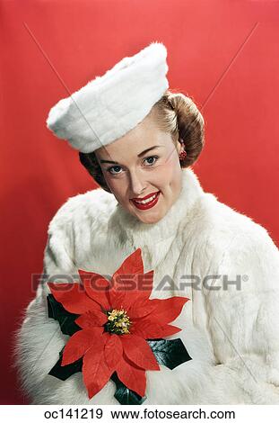 1940S Portrait Smiling Woman Wearing White Fur Overcoat And Hat Holding Poinsettia Looking At Camera View Large Photo Image Stock Photo - 1940S Portrait Smiling Woman Wearing White Fur Overcoat And Hat Holding Poinsettia Looking At Camera. Fotosearch