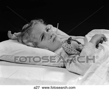 1940S Sick Little Girl Lying In Bed With Doll Under Arm & Thermometer In Mouth View Large Photo Image Stock Photo - 1940S Sick Little Girl Lying In Bed With Doll Under Arm & Thermometer In Mouth. Fotosearch