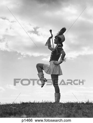 1940S Silhouette Of Majorette Against Sky And Clouds View Large Photo Image Stock Photograph - 1940S Silhouette Of Majorette Against Sky And Clouds. Fotosearch